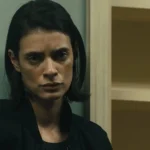 Close-up portrait of Laysla De Oliveira as Cruz Manuelos in a black jacket looking solemn in Special Ops: Lioness.