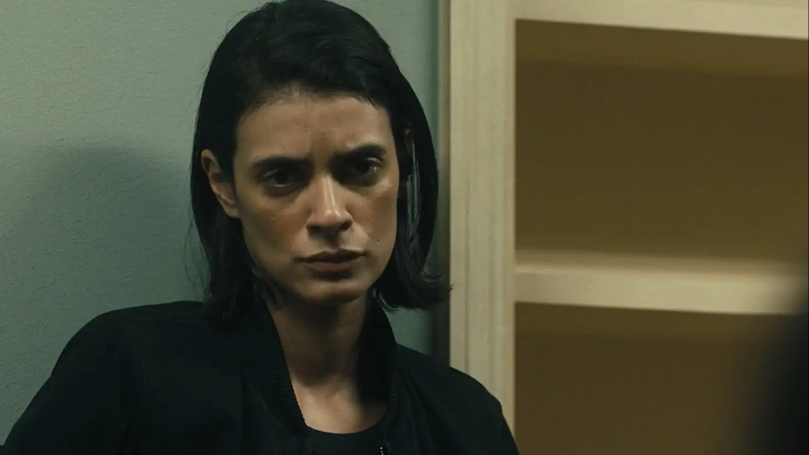 Close-up portrait of Laysla De Oliveira as Cruz Manuelos in a black jacket looking solemn in Special Ops: Lioness.