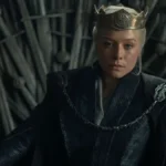 Emma D'Arcy as Queen Rhaenyra Targaryen wearing a crown while seated on the Iron Throne in House of the Dragon.
