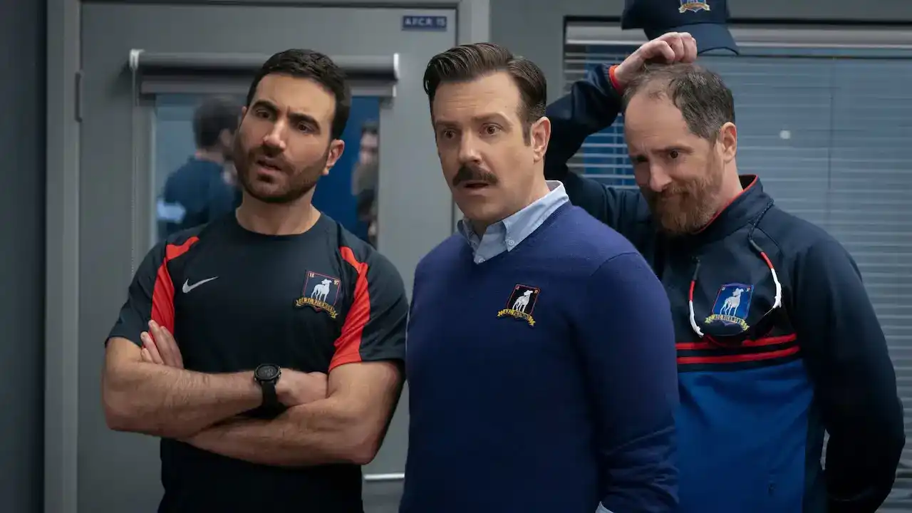 Actors Brett Goldstein, Jason Sudeikis, and Brendan Hunt in a promotional still from the comedy series Ted Lasso