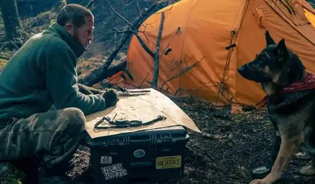 Brad Pitt with his canine co-star in a scene from the survival thriller movie Heart of the Beast.