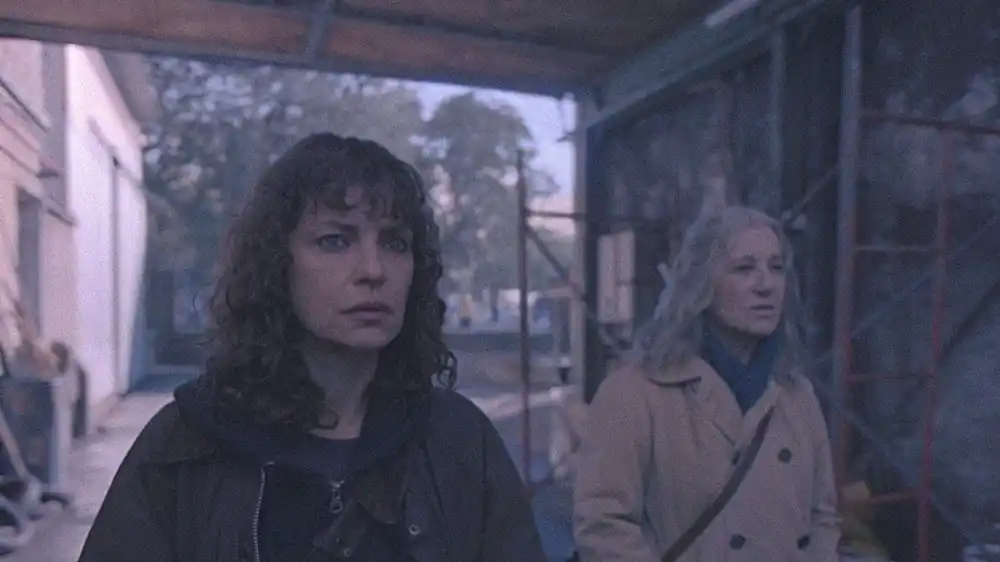 Dolores Fonzi (left) alongside another individual in a scene that closely resembles promotional material or footage from the supernatural horror series My Sad Dead (Mis muertos tristes) directed by Pablo Larraín.