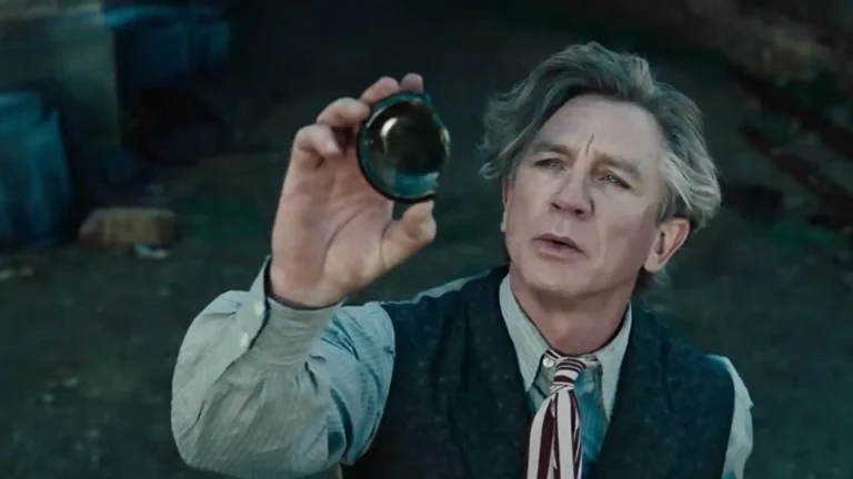Daniel Craig as Uncle Andrew (Andrew Ketterley) examining a piece of magic ring or glass in the trailer for Greta Gerwig's film Narnia: The Magician's Nephew